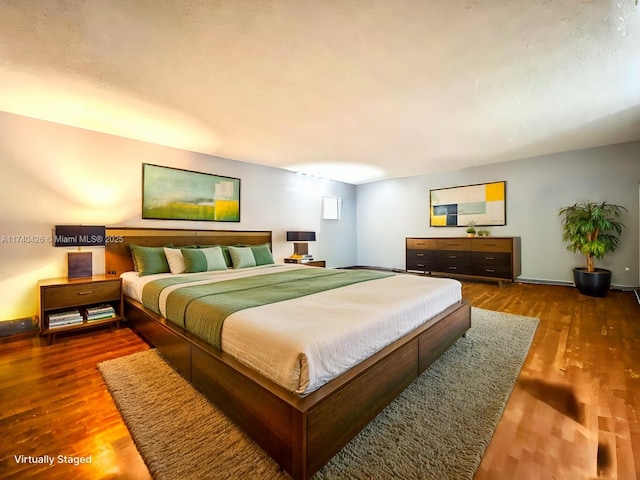 bedroom featuring dark hardwood / wood-style floors