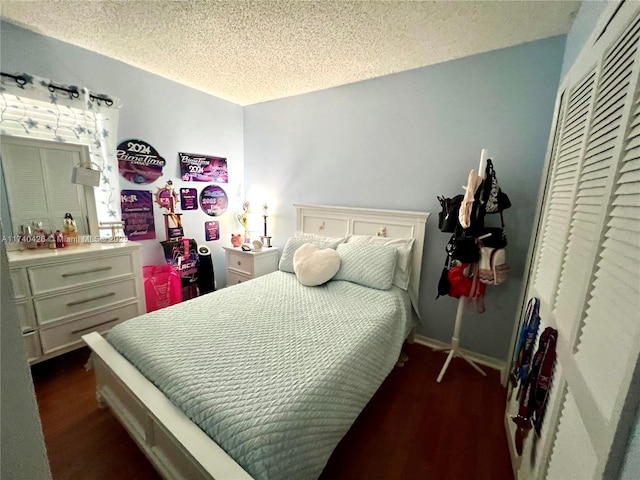 bedroom featuring dark wood-type flooring, a closet, and a textured ceiling