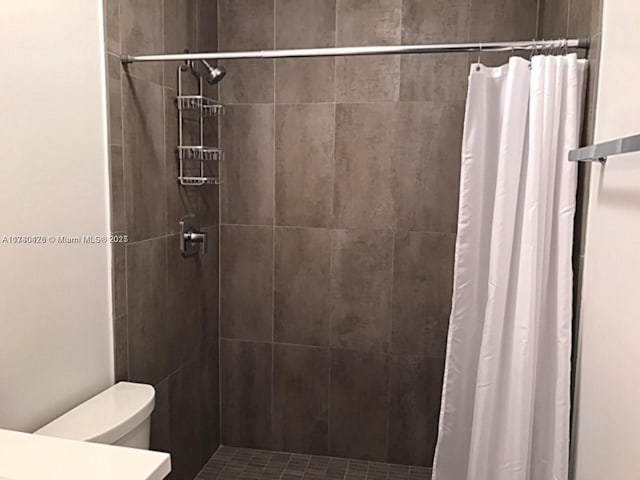 bathroom featuring toilet, a shower stall, and vanity