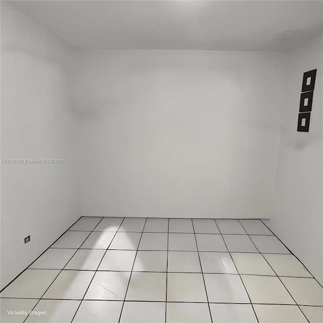 empty room with light tile patterned floors