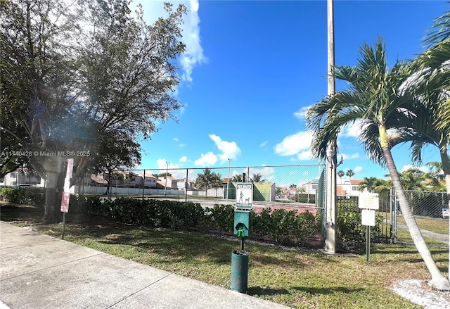 exterior space with fence and a yard