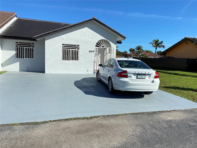 view of property exterior featuring a lawn