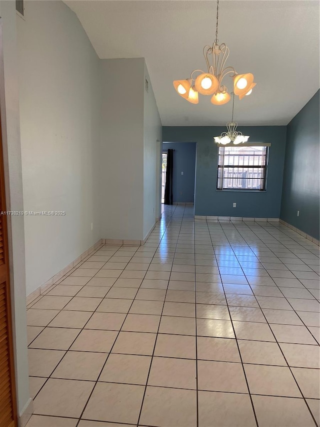 unfurnished room featuring light tile patterned flooring, a chandelier, and vaulted ceiling