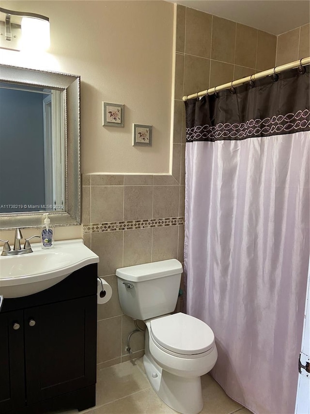 bathroom with tile walls, vanity, a shower with curtain, tile patterned floors, and toilet