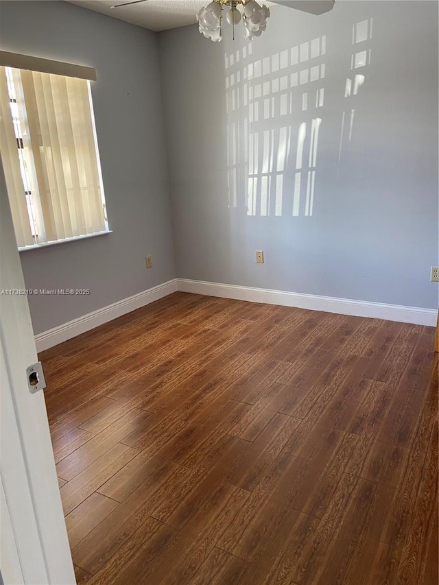 unfurnished room with dark wood-type flooring and ceiling fan