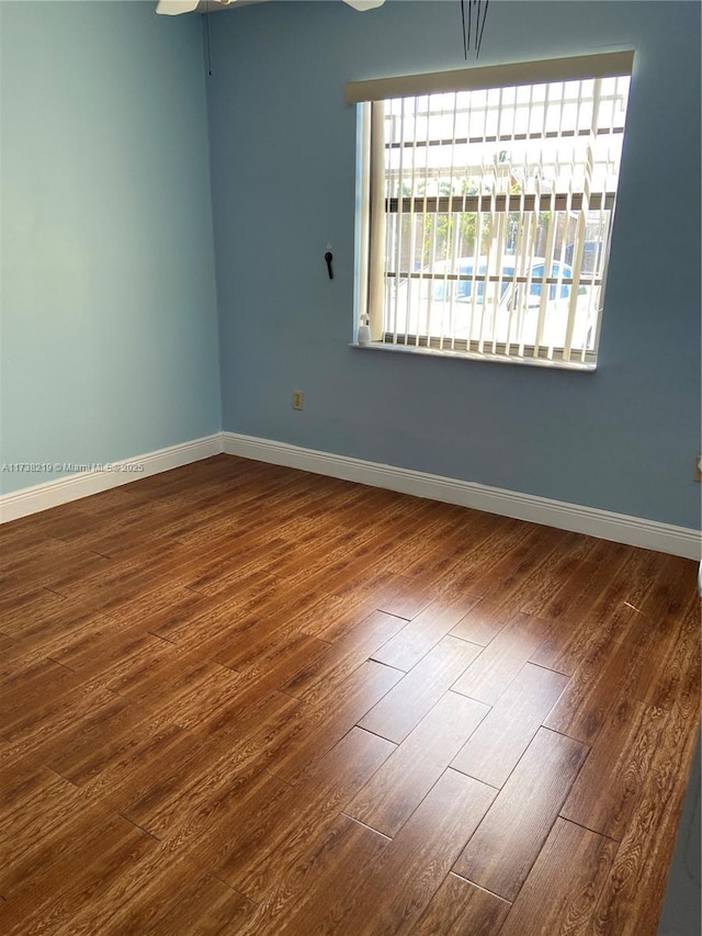 empty room with hardwood / wood-style floors