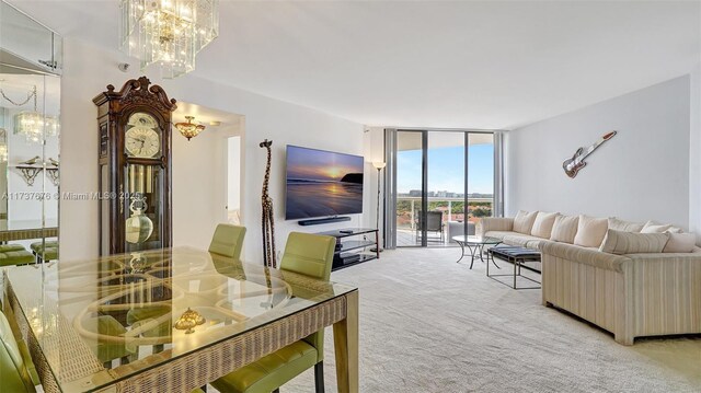 carpeted living room featuring an inviting chandelier and a wall of windows