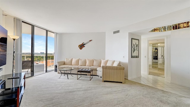 carpeted living room with floor to ceiling windows