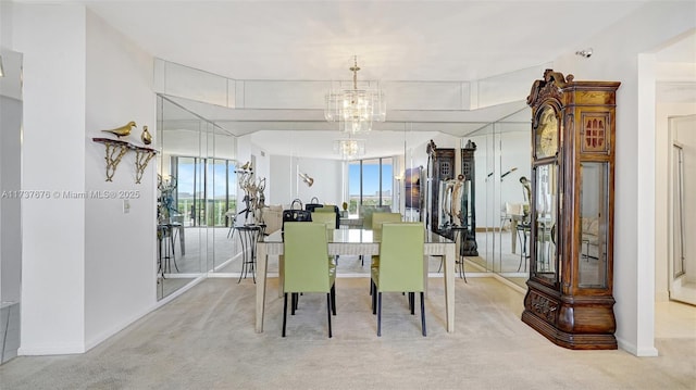 carpeted dining area featuring a notable chandelier