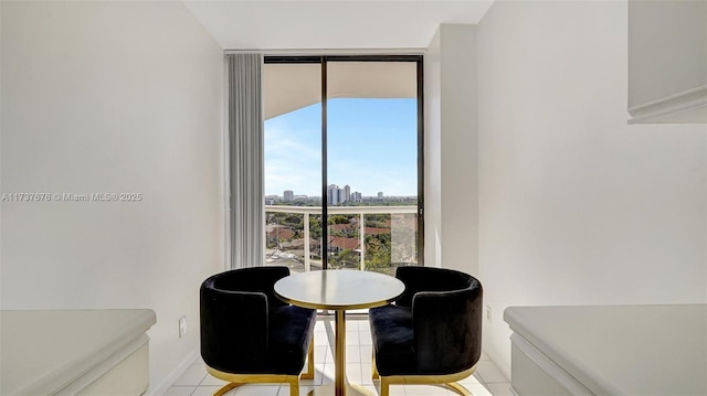 living area with floor to ceiling windows and light tile patterned floors