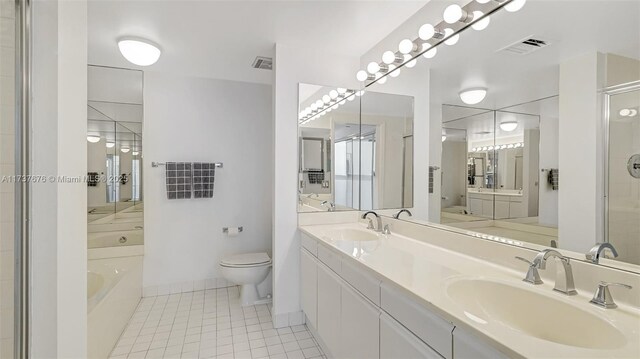 full bathroom with tile patterned flooring, vanity, independent shower and bath, and toilet