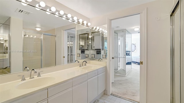 bathroom with vanity and a shower with shower door