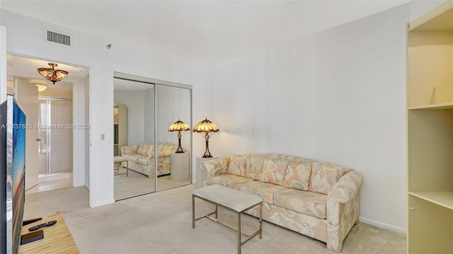 sitting room featuring light colored carpet