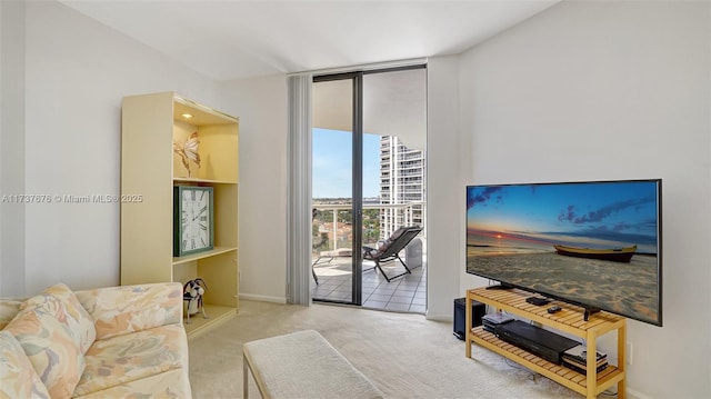 carpeted living room featuring a wall of windows