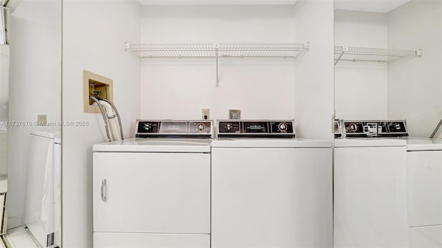 clothes washing area with separate washer and dryer