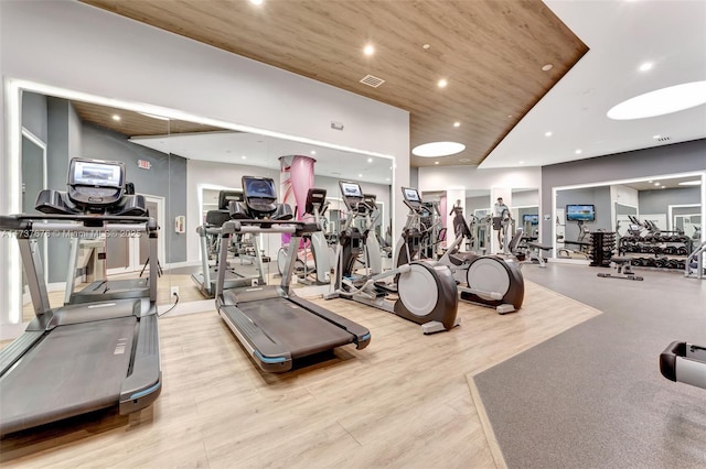 workout area featuring wood ceiling and light hardwood / wood-style flooring