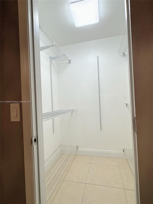 walk in closet featuring light tile patterned floors