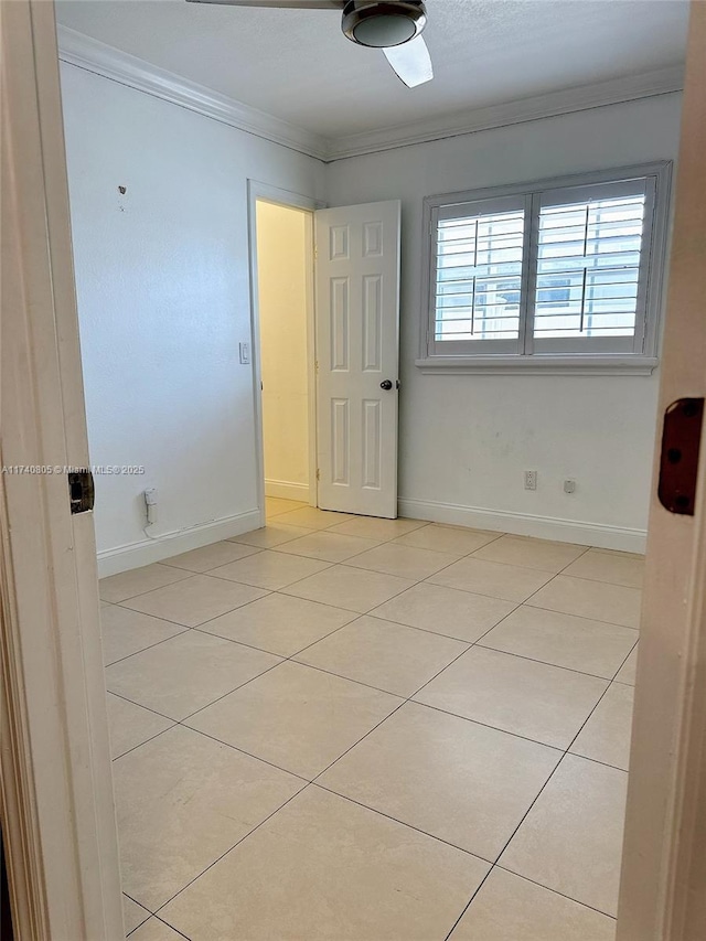 unfurnished room with crown molding and light tile patterned floors