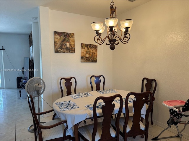 tiled dining space with an inviting chandelier