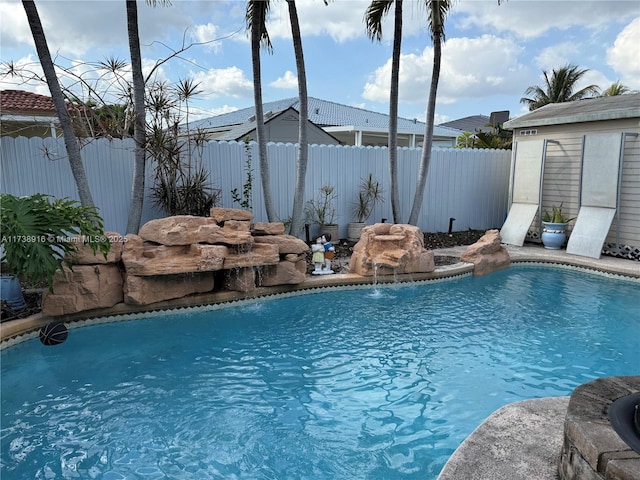 view of pool with an outdoor structure and pool water feature