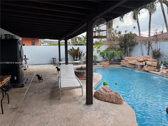 view of pool with pool water feature and a patio area