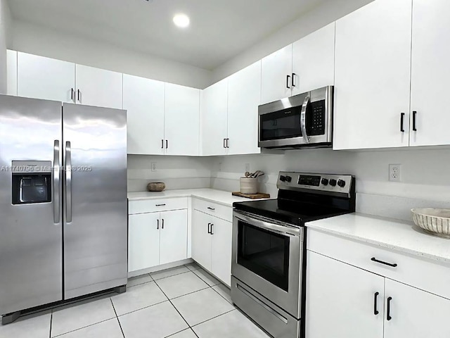 kitchen featuring white cabinetry, appliances with stainless steel finishes, and light tile patterned floors