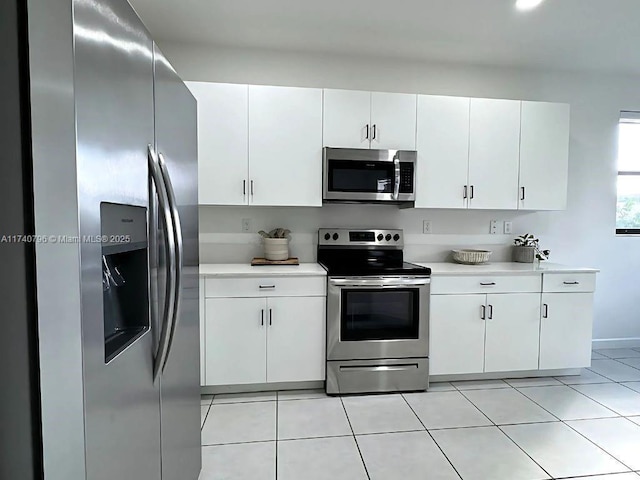 kitchen featuring light tile patterned floors, white cabinets, and appliances with stainless steel finishes