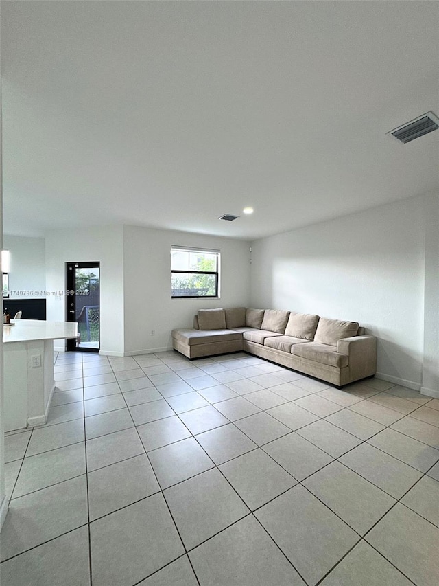 unfurnished living room with light tile patterned floors