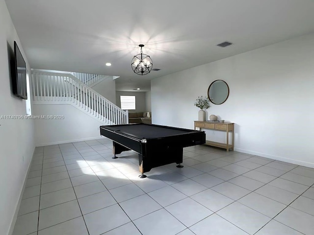 playroom with pool table, a chandelier, and light tile patterned floors