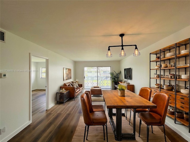 dining area with dark hardwood / wood-style flooring