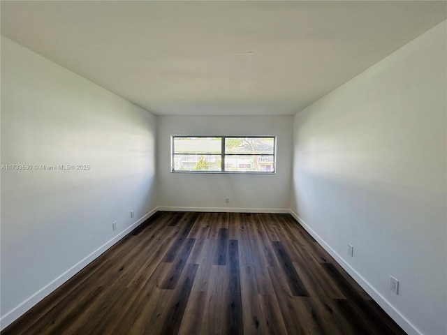 empty room featuring dark wood-type flooring