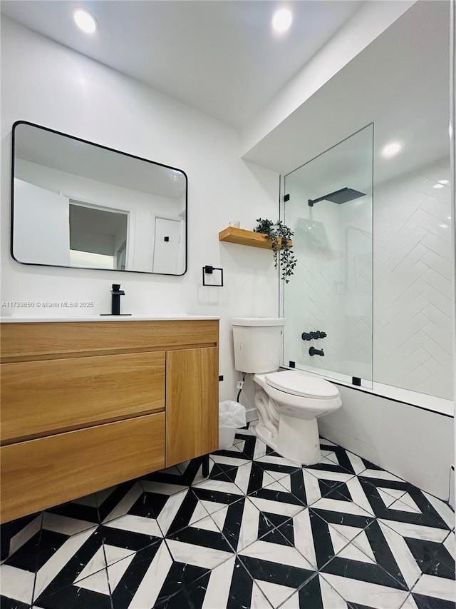 full bathroom featuring tiled shower / bath, vanity, and toilet