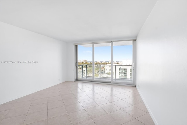 tiled empty room with floor to ceiling windows