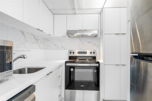 kitchen with white cabinetry, sink, tasteful backsplash, and appliances with stainless steel finishes