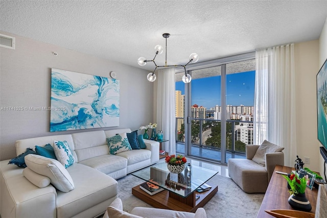 living room featuring floor to ceiling windows and a textured ceiling