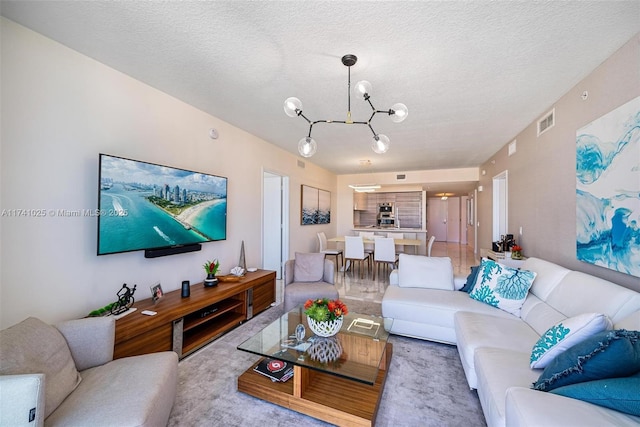 carpeted living room with an inviting chandelier and a textured ceiling