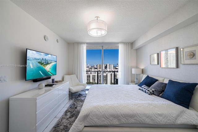 bedroom with access to exterior and a textured ceiling