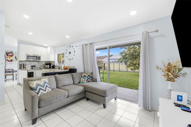 tiled living room with lofted ceiling and sink