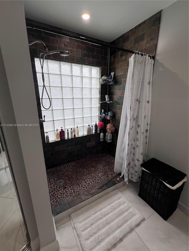 bathroom with walk in shower and tile patterned floors