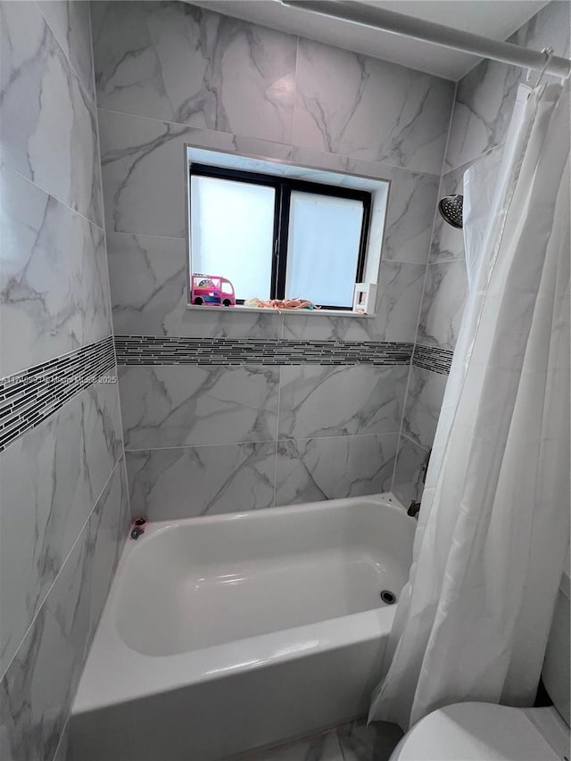 bathroom with shower / bath combination with curtain and toilet