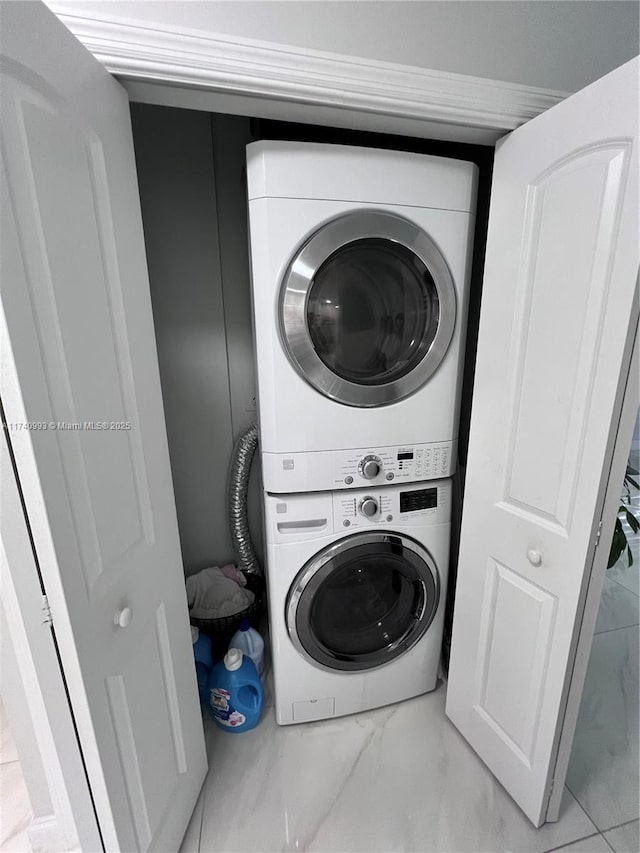 laundry area with stacked washer / dryer