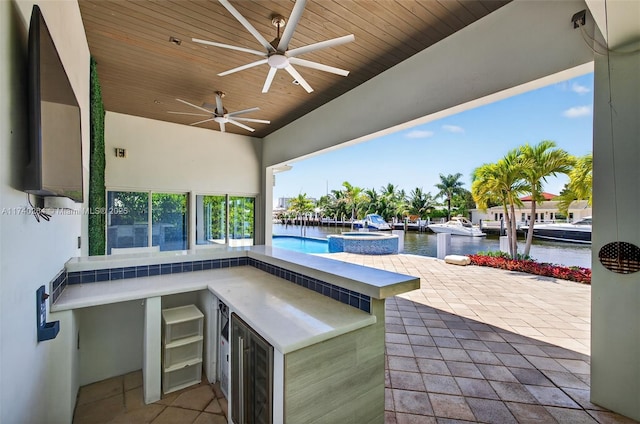 2816 NE 24th Pl, Fort Lauderdale, FL 33305 - view of patio / terrace with exterior kitchen, a water view, and ceiling fan