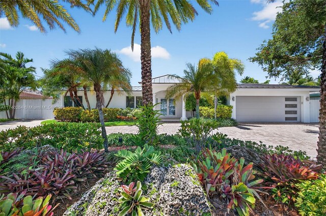2816 NE 24th Pl, Fort Lauderdale, FL 33305 - view of front of home featuring a garage, stucco siding, and decorative driveway