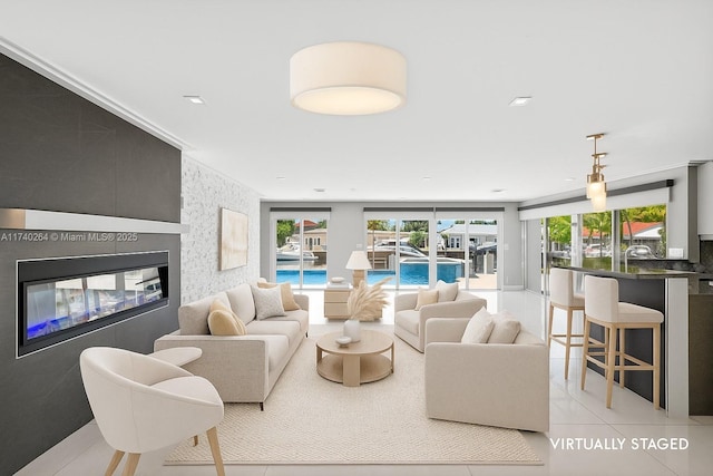2816 NE 24th Pl, Fort Lauderdale, FL 33305 - tiled living area with a glass covered fireplace
