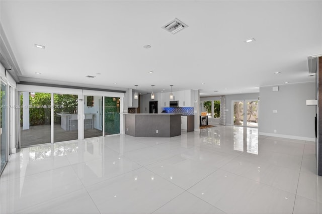 2816 NE 24th Pl, Fort Lauderdale, FL 33305 - unfurnished living room with light tile patterned floors, french doors, and recessed lighting