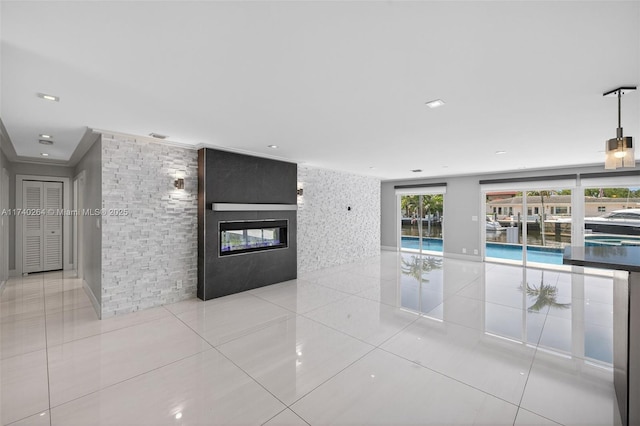 2816 NE 24th Pl, Fort Lauderdale, FL 33305 - unfurnished living room featuring tile patterned floors and a multi sided fireplace
