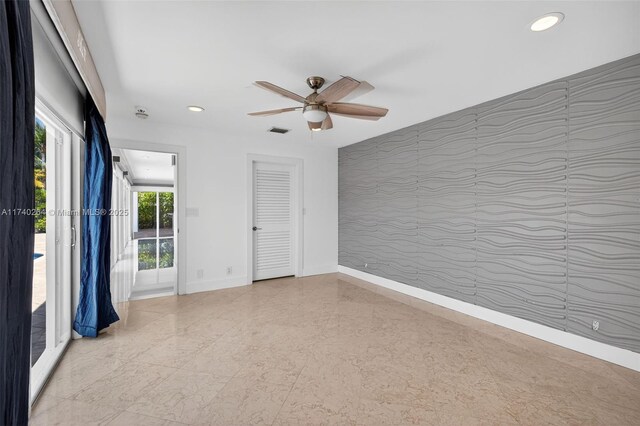2816 NE 24th Pl, Fort Lauderdale, FL 33305 - empty room with an accent wall, wallpapered walls, recessed lighting, and ceiling fan
