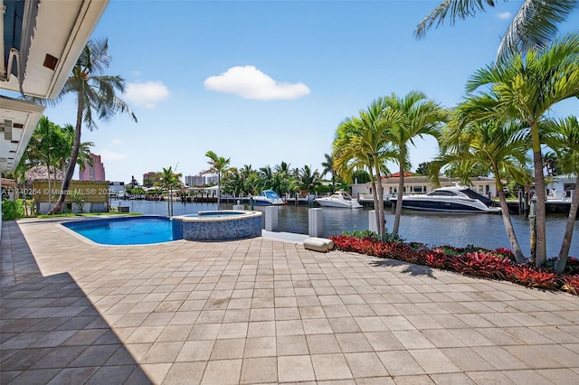 2816 NE 24th Pl, Fort Lauderdale, FL 33305 - view of pool featuring a water view, a pool with connected hot tub, and a patio area