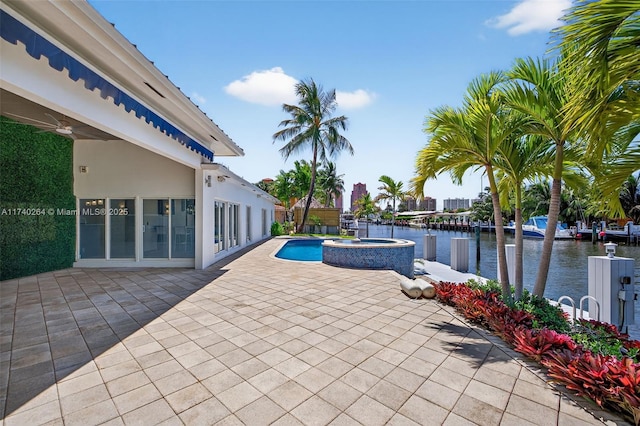 2816 NE 24th Pl, Fort Lauderdale, FL 33305 - view of patio featuring a water view and a pool with connected hot tub