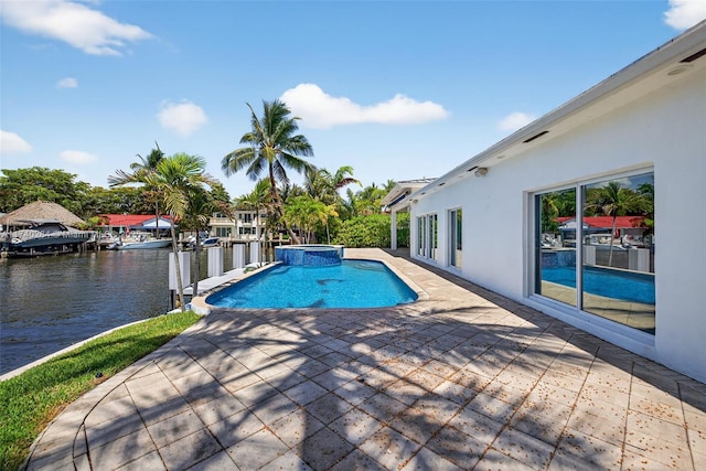 2816 NE 24th Pl, Fort Lauderdale, FL 33305 - view of pool featuring a water view, a patio area, and a pool with connected hot tub